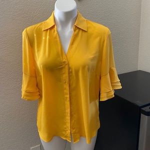 Mustard color blouse.